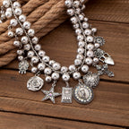 Necklace with pendants in the shape of a rose, pentagram, oval, heart and cross