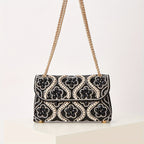 Elegant clutch with a pattern and glittering rhinestones