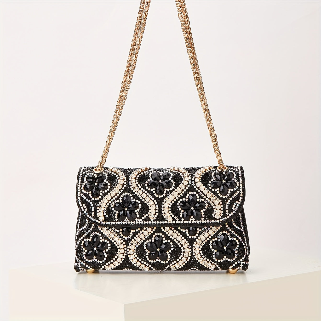 Elegant clutch with a pattern and glittering rhinestones
