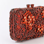 Evening clutch with glass stones and floral pattern