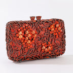 Evening clutch with glass stones and floral pattern