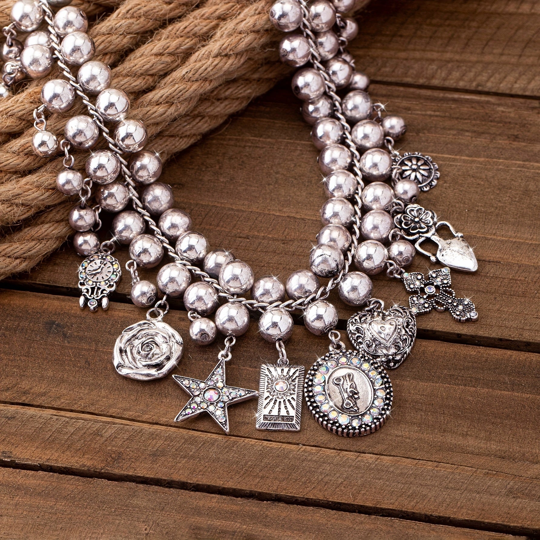 Necklace with pendants in the shape of a rose, pentagram, oval, heart and cross