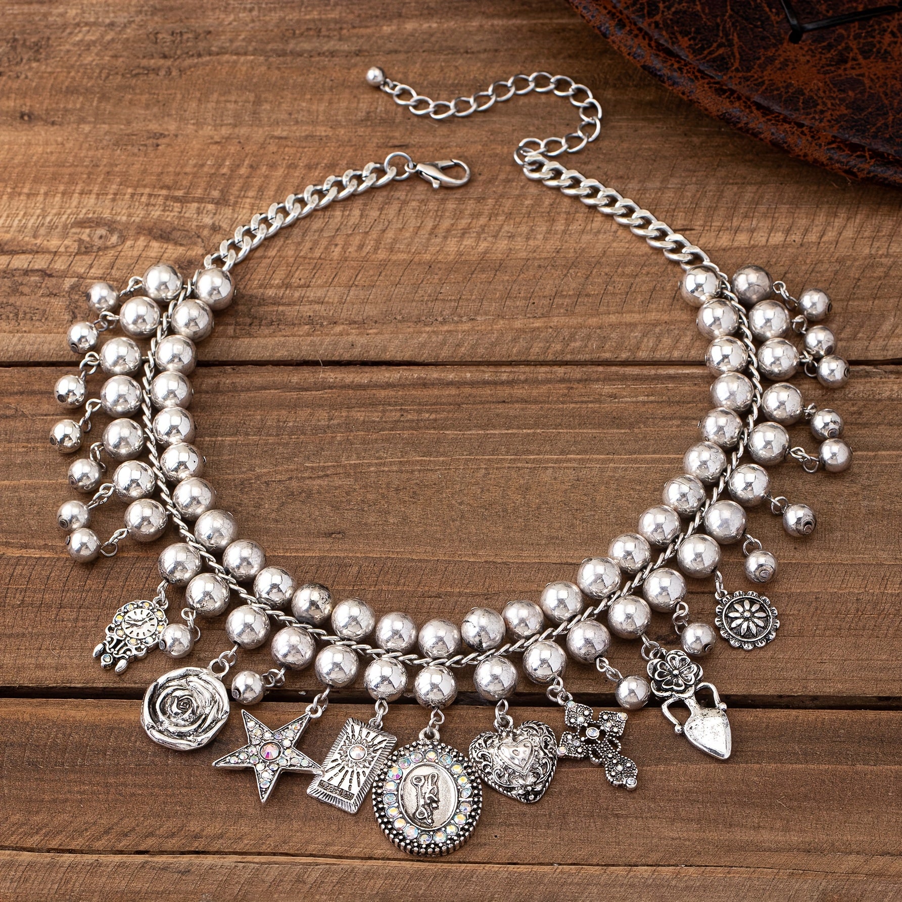 Necklace with pendants in the shape of a rose, pentagram, oval, heart and cross