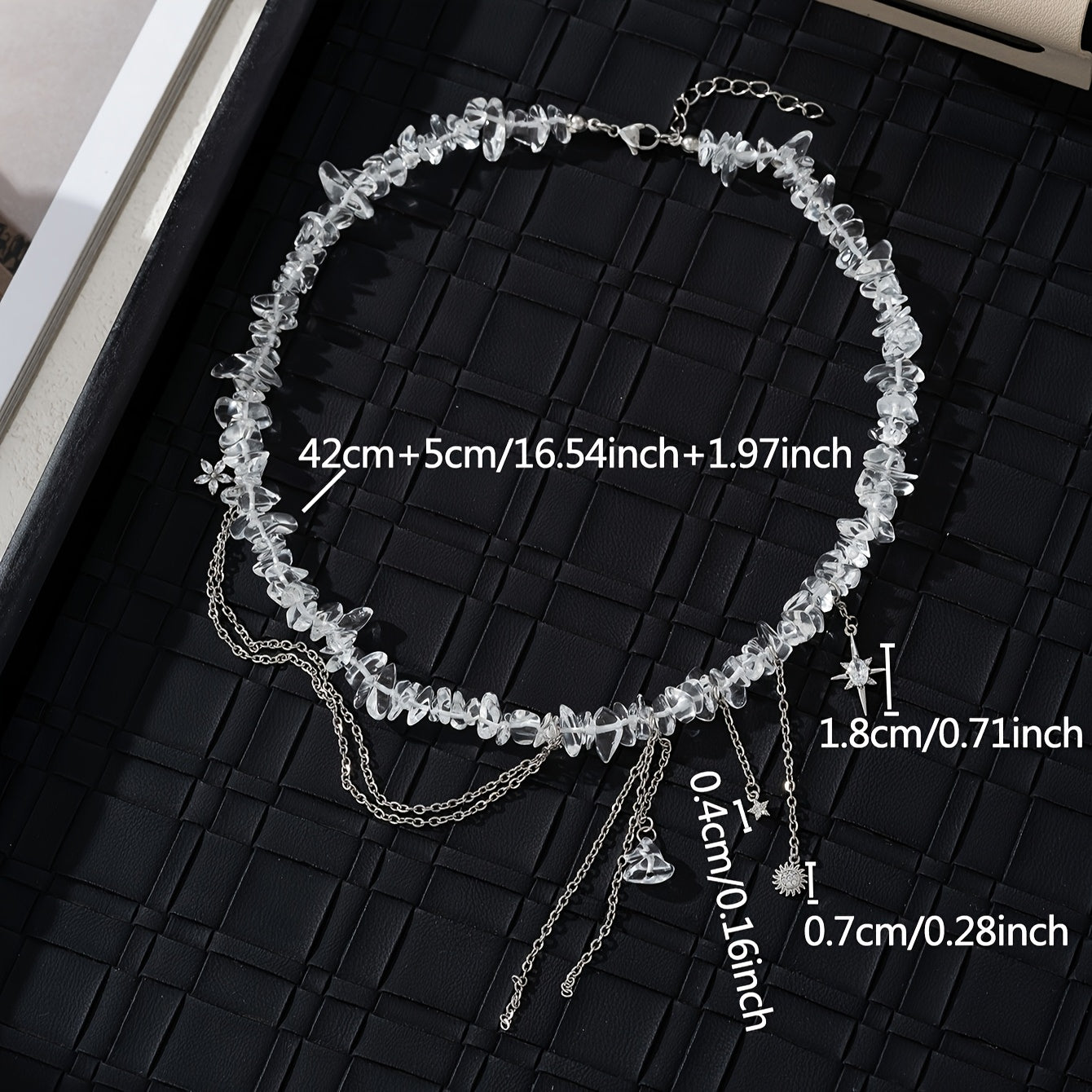 Necklace with stones, zircons and star, flower and sun pendants.