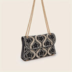 Elegant clutch with a pattern and glittering rhinestones
