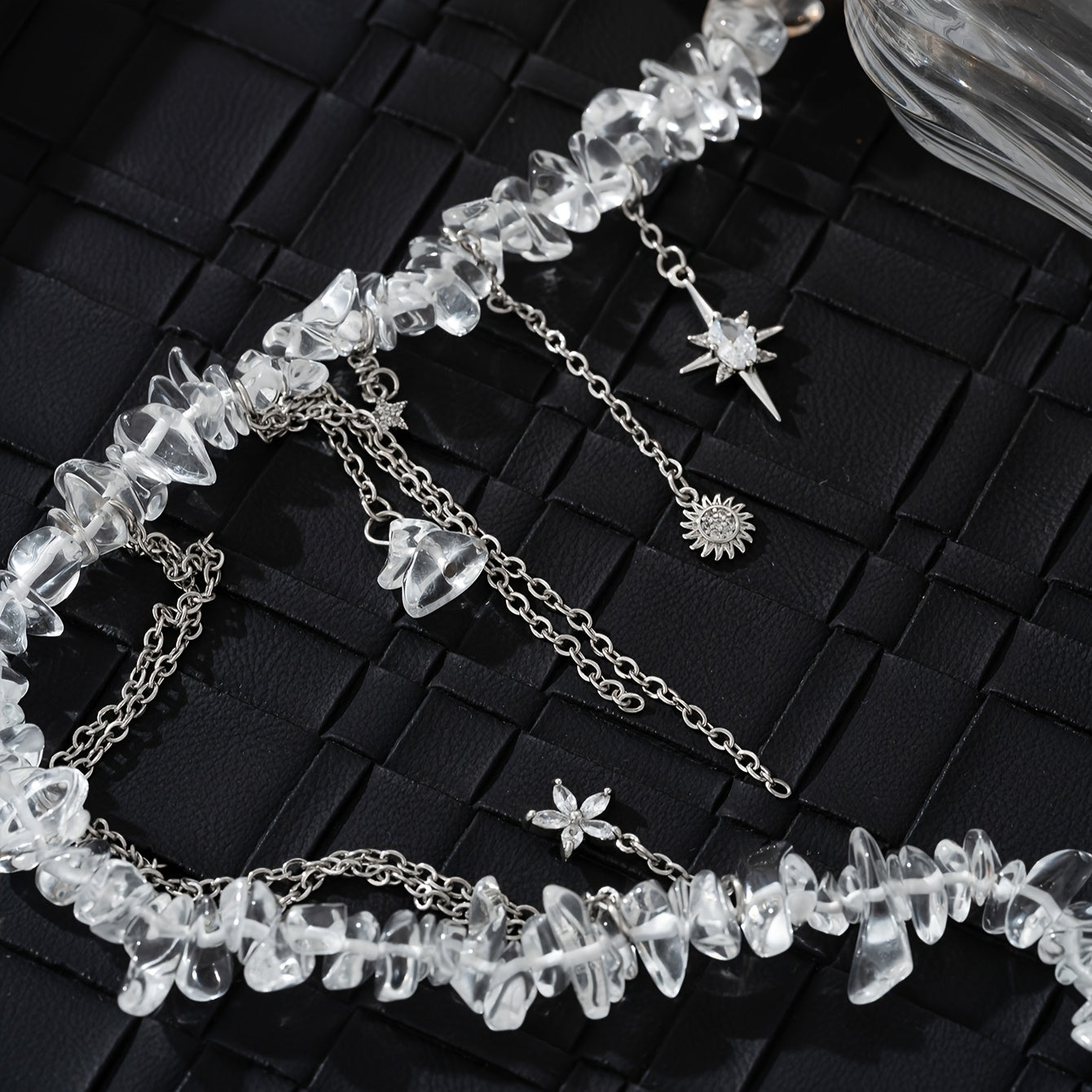 Necklace with stones, zircons and star, flower and sun pendants.