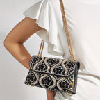 Elegant clutch with a pattern and glittering rhinestones