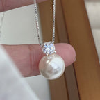 Elegant classic necklace with an inlaid artificial pearl and zircon