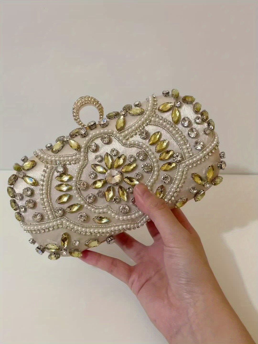 Stylish evening clutch decorated with luxurious beads and glittering rhinestones