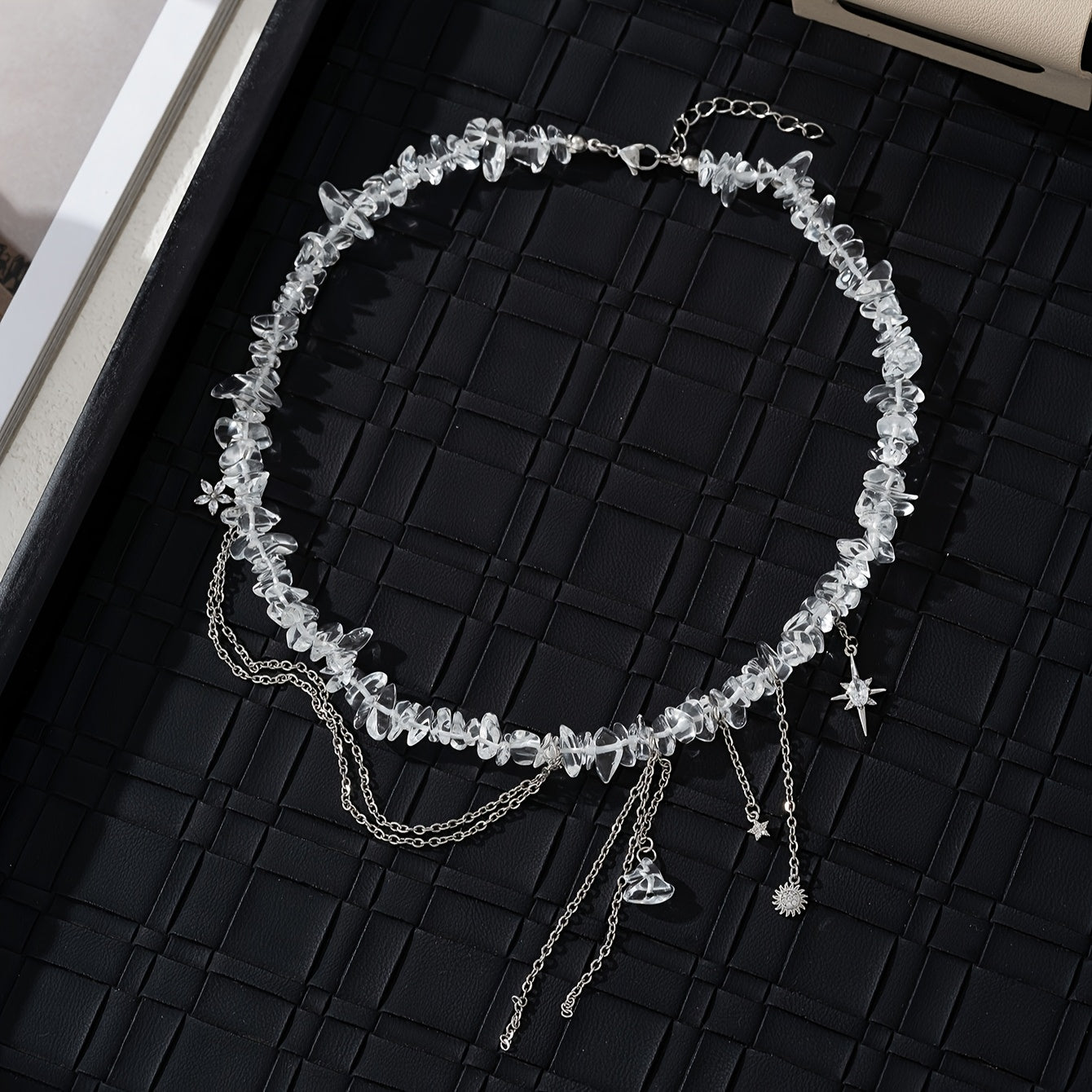 Necklace with stones, zircons and star, flower and sun pendants.