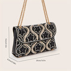 Elegant clutch with a pattern and glittering rhinestones