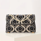 Elegant clutch with a pattern and glittering rhinestones