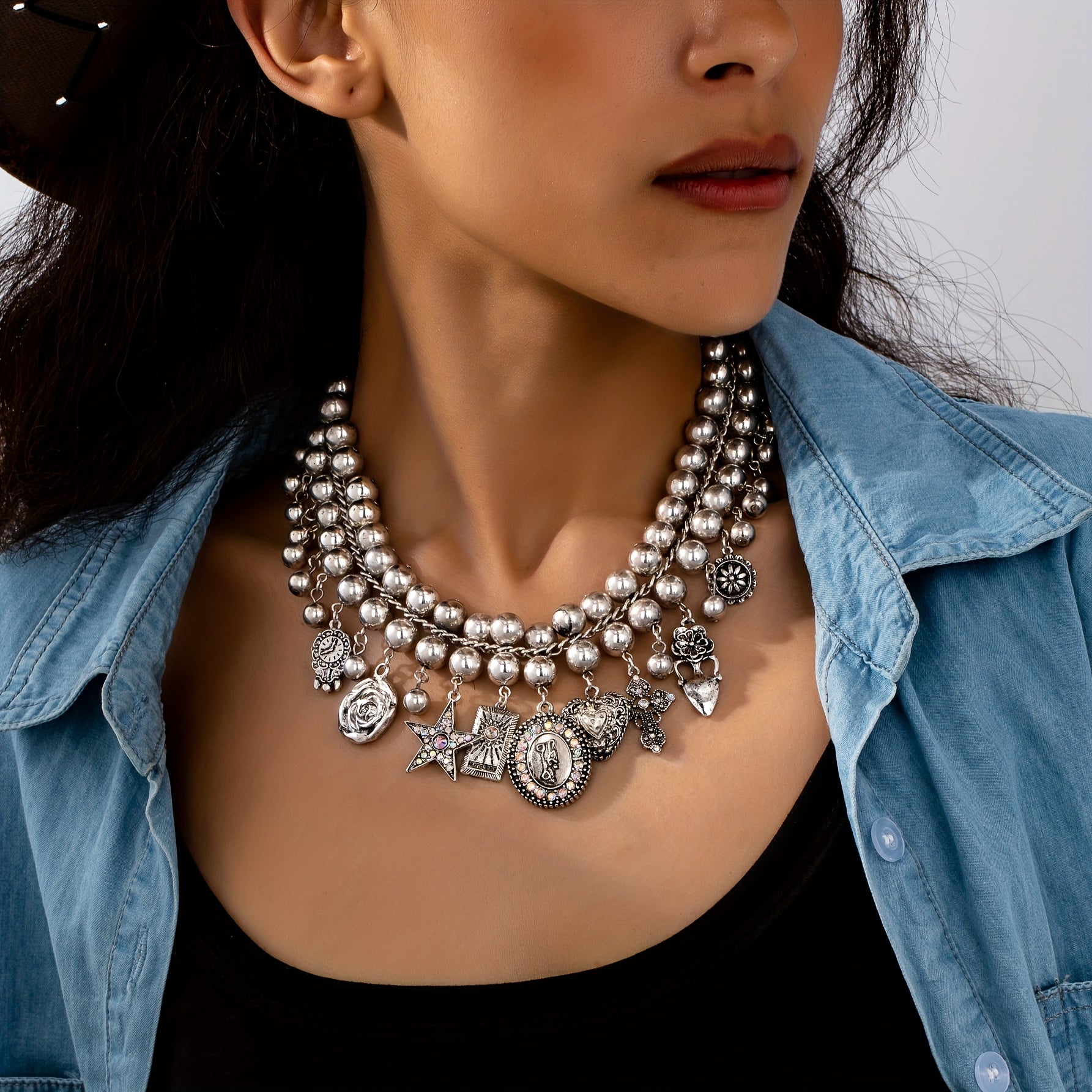 Necklace with pendants in the shape of a rose, pentagram, oval, heart and cross