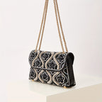 Elegant clutch with a pattern and glittering rhinestones