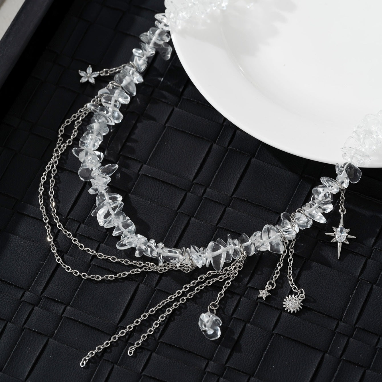 Necklace with stones, zircons and star, flower and sun pendants.
